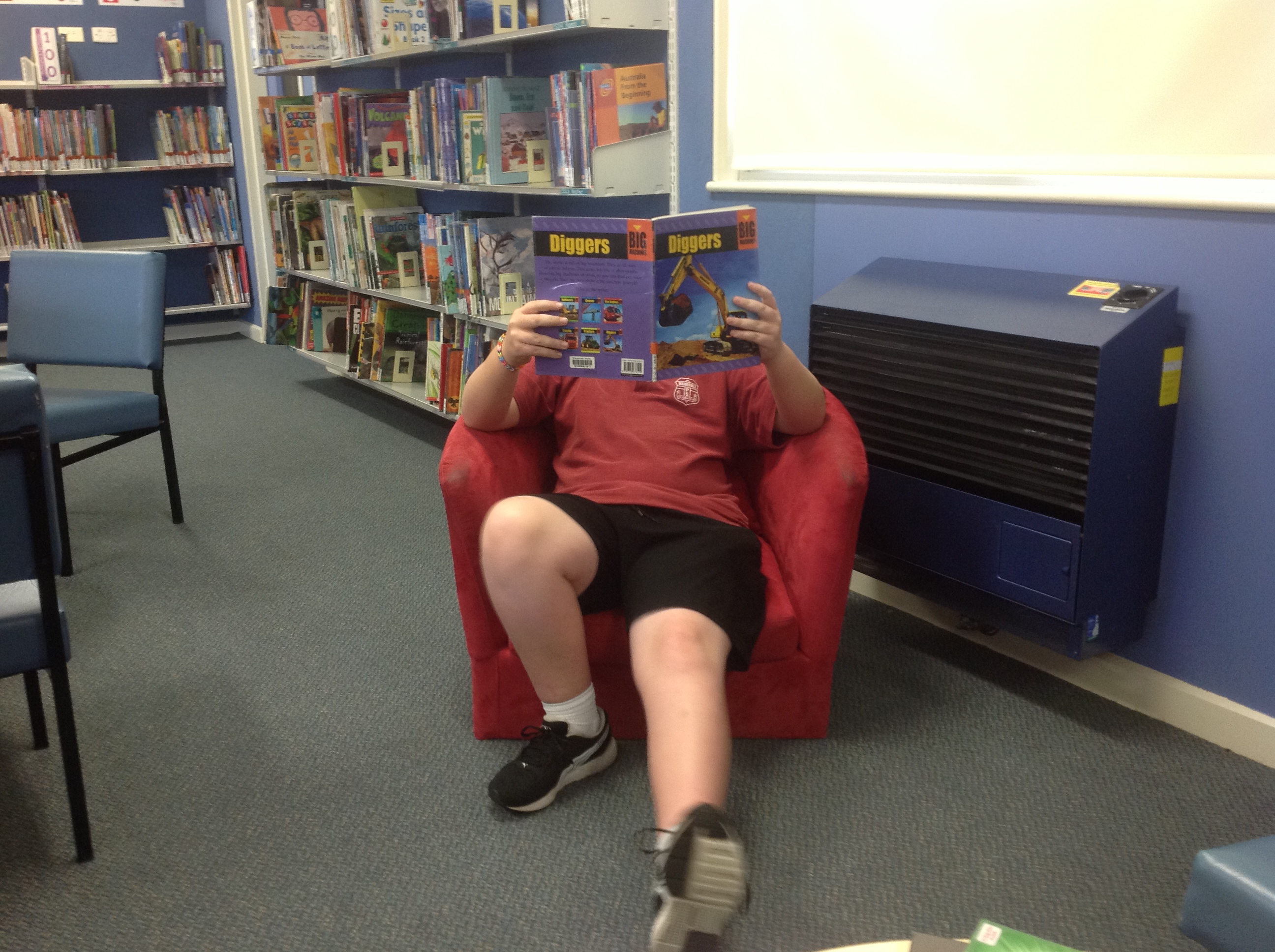 Student reading book in library.